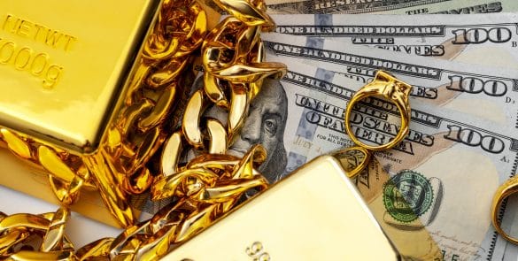 Jewelry buyer, pawn shop and buy and sell precious metals concept theme with a pile of cash in US dollars, golden rings, necklace bracelet and gold bullion isolated on white background